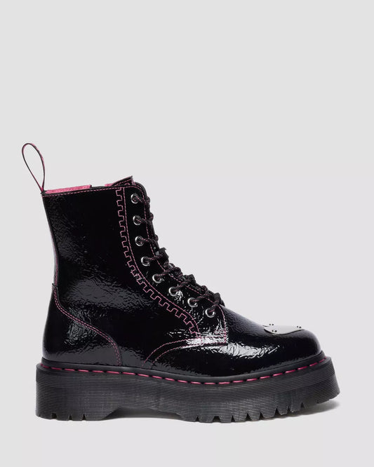 Black patent leather boot with pink trim on a light gray background