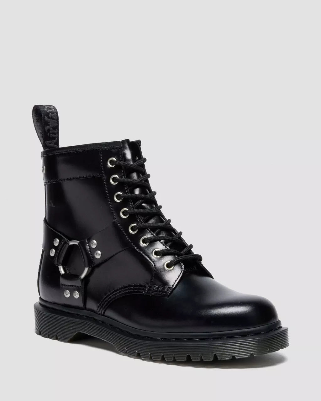 Black leather boot with metallic accents on a light gray background