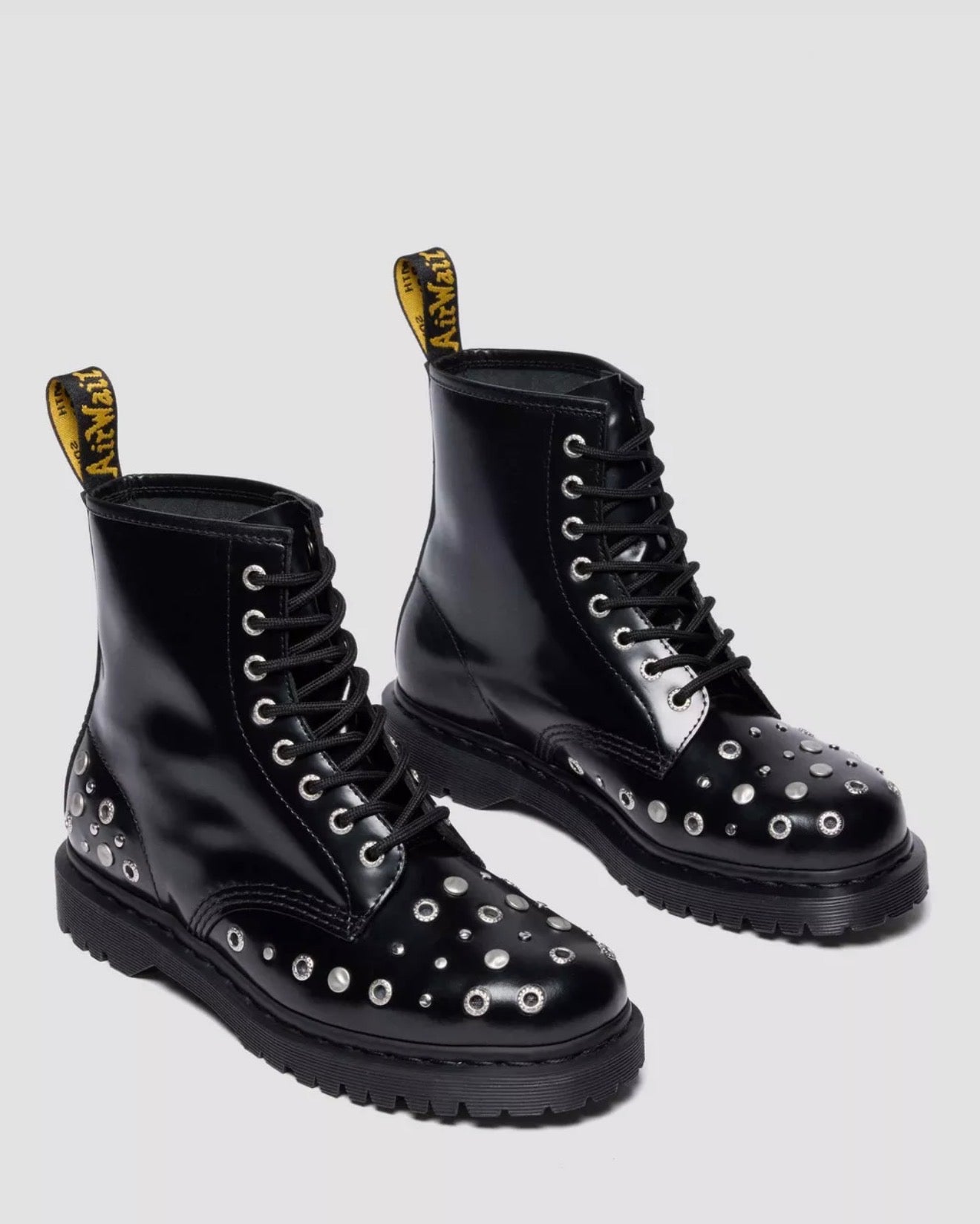 Black studded boots on a light gray background