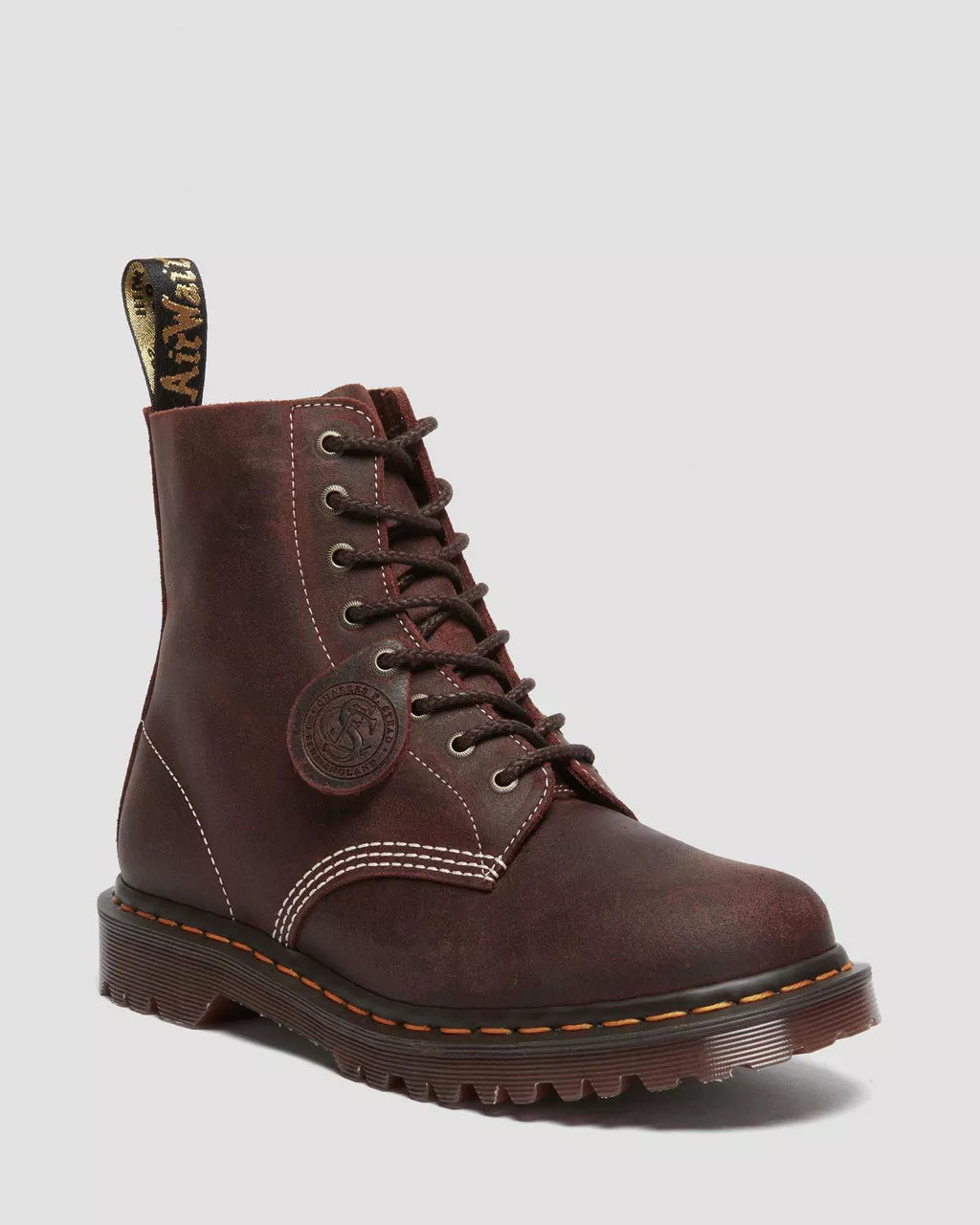 Brown leather boot with laces on a light gray background