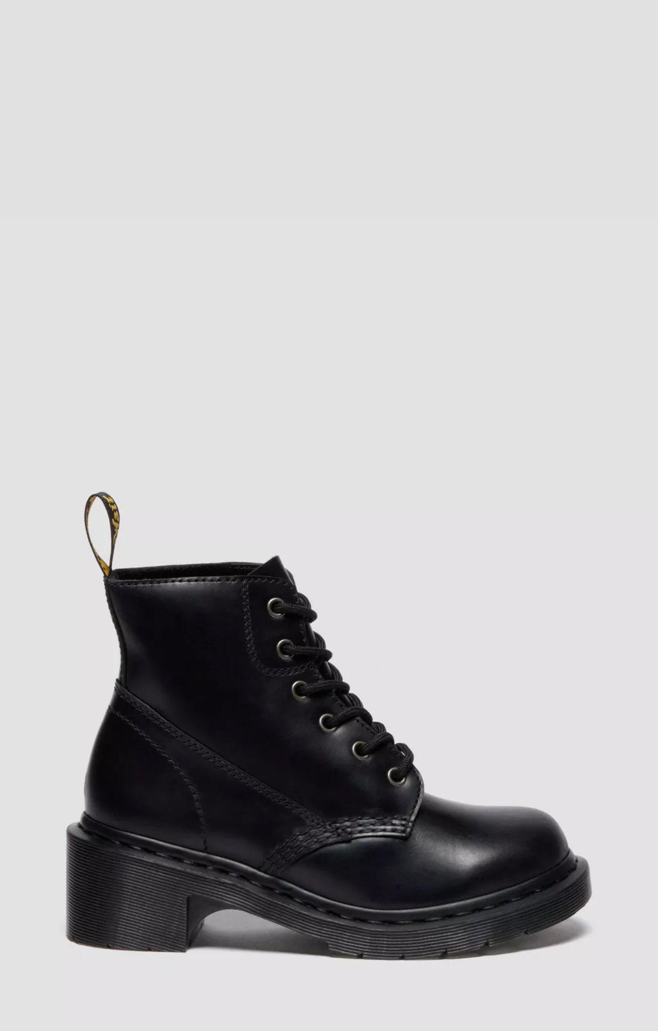 Black leather boot on a light gray background