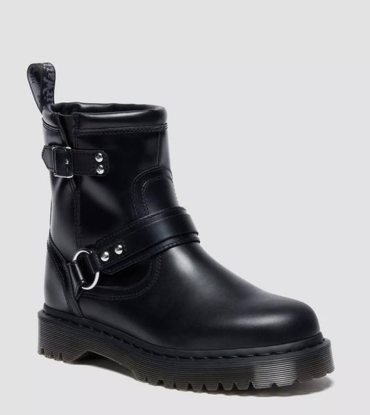 Black leather boot with buckles on a light gray background
