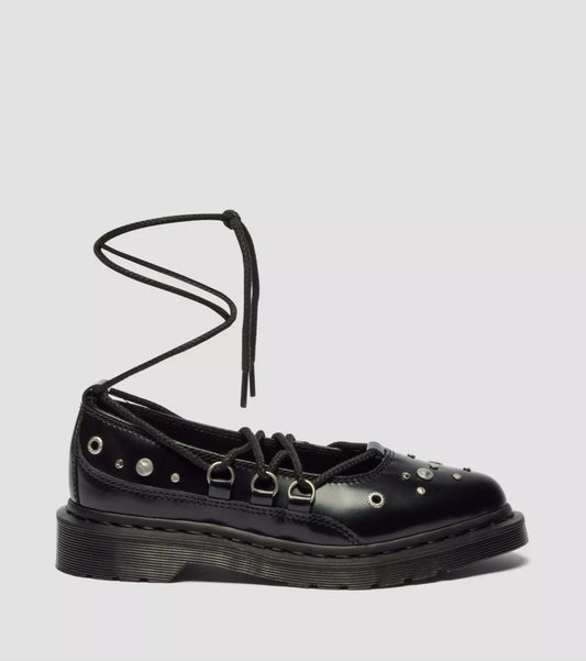 Black leather shoe with unique strap design on a light gray background