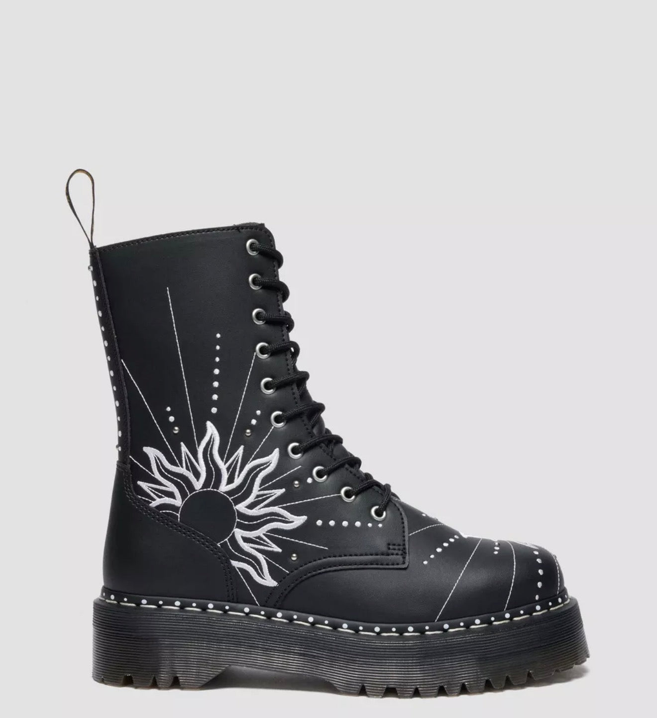 Black boot with white floral design on a gray background