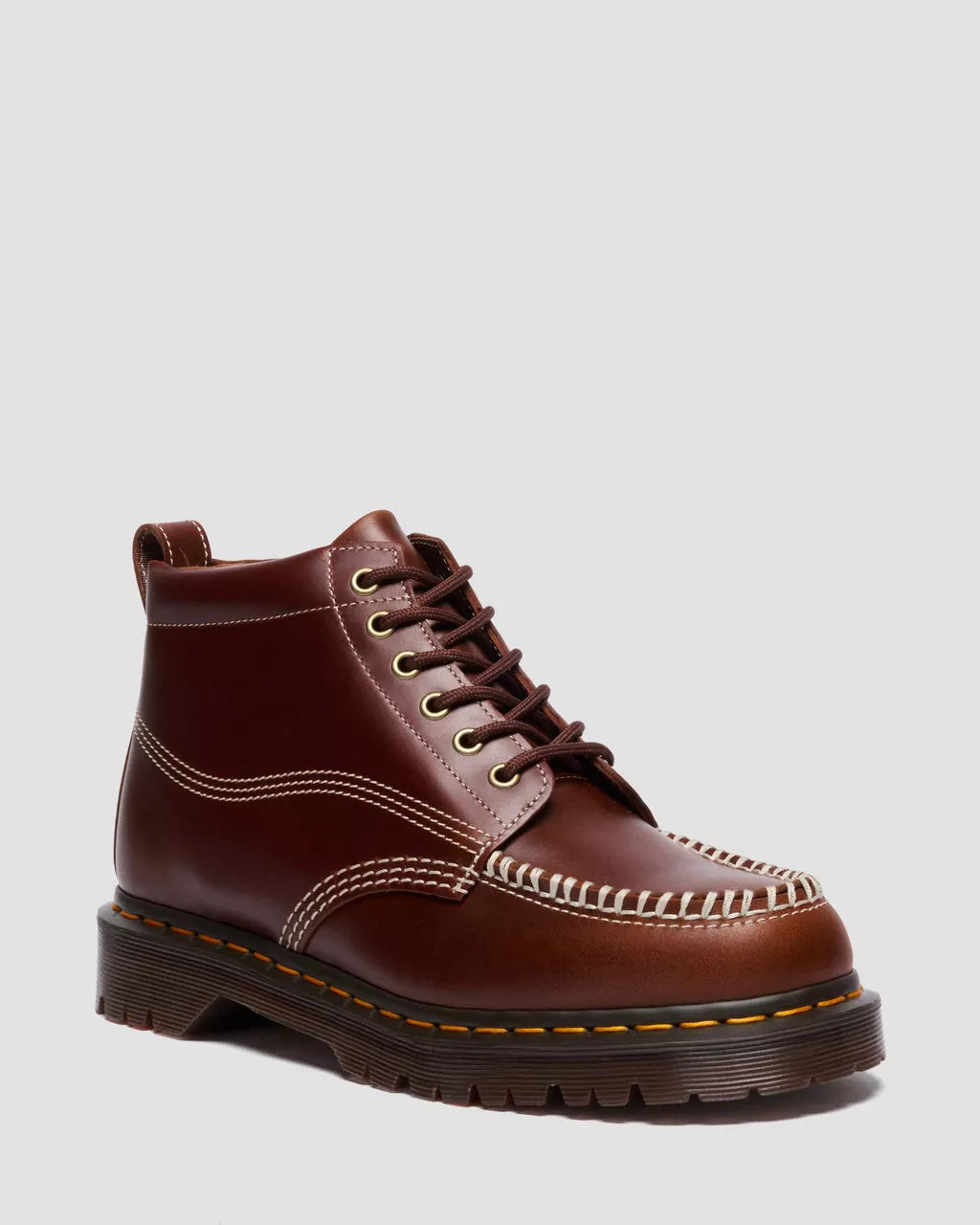 Brown leather boot with stitching detail on a light gray background