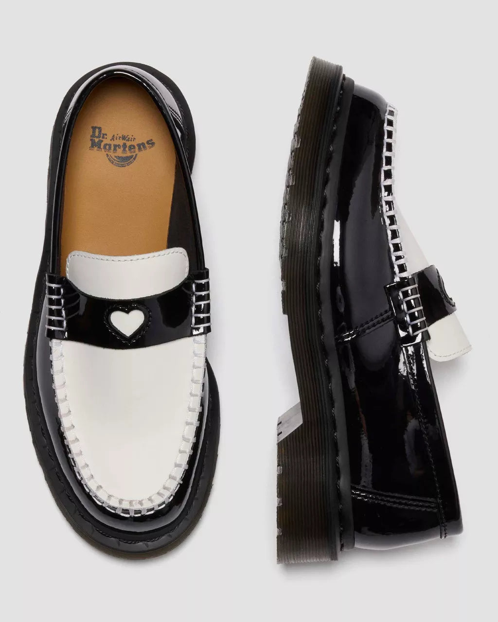 Black patent leather loafer with heart design on a white background