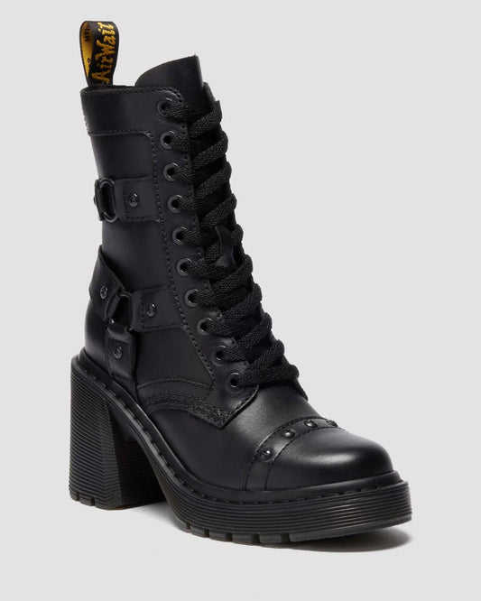 Black leather boot with high block heel on a light gray background