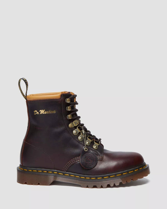 Brown leather boot with gold accents on a light gray background