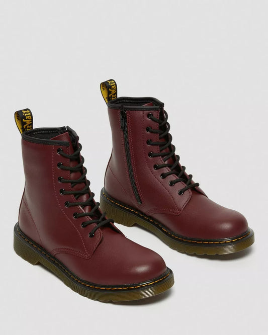 A pair of cherry red leather lace-up boots for kids with a visible yellow brand tag on the top.