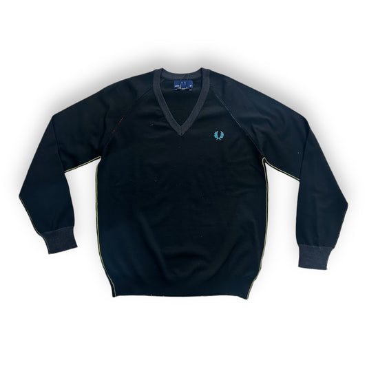 A black Fred Perry sweater with a V-neck collar and a small blue and yellow stripe on the sleeve.
