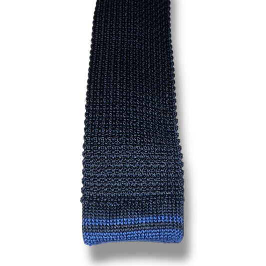 Black knitted tie with a blue stripe on a white background