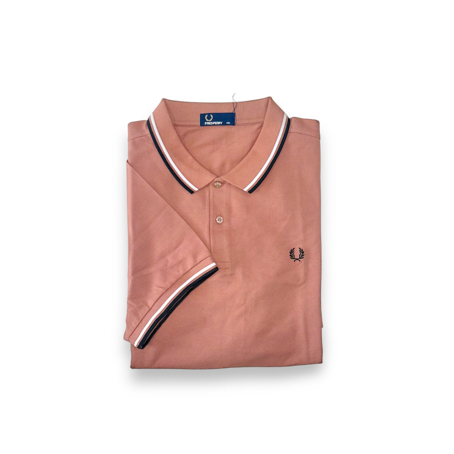 A pink Fred Perry polo shirt with a collar, featuring black stripes on the sleeves and the brand's logo on the chest.