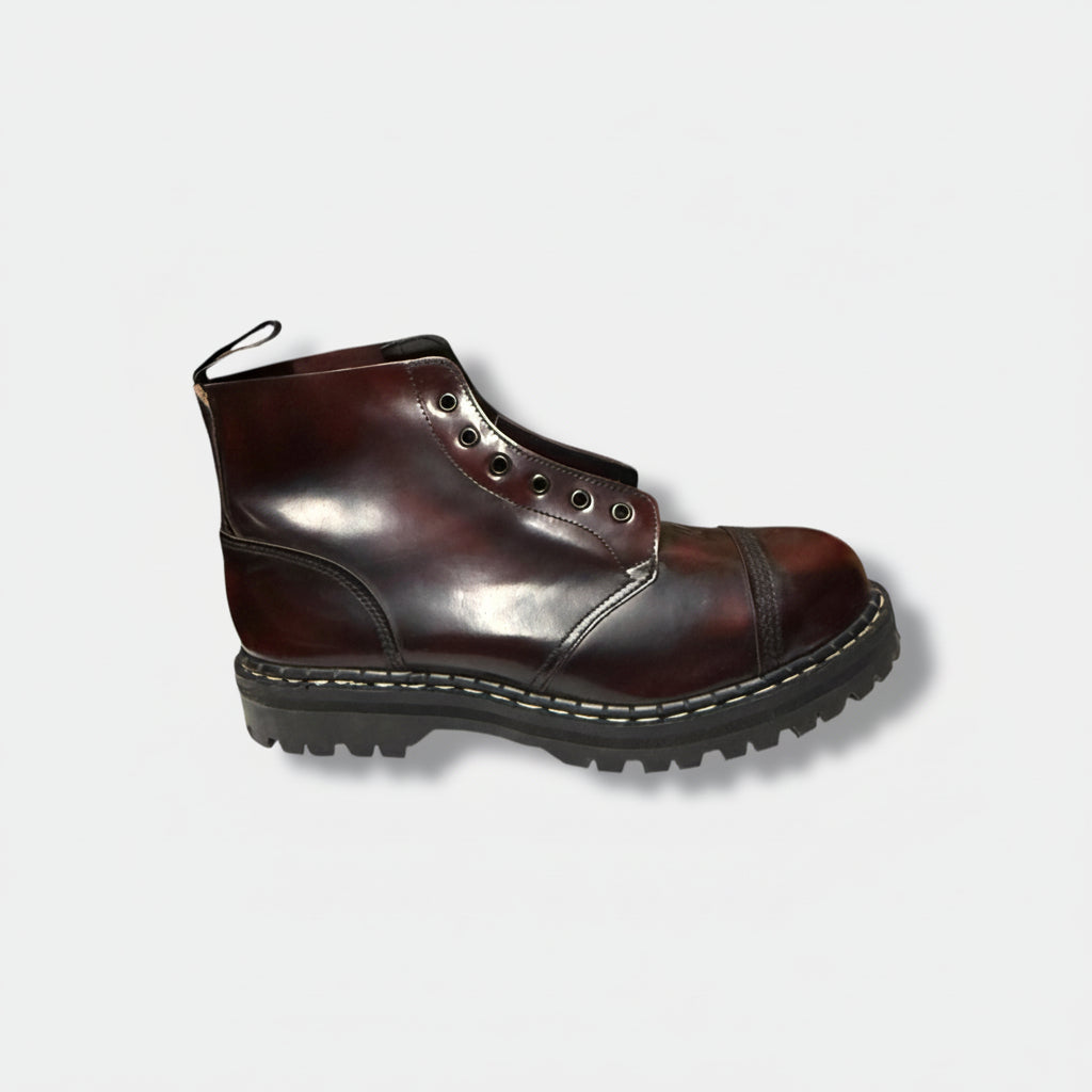 A burgundy leather boot with a steel cap and six eyelets for lacing, set against a white background.