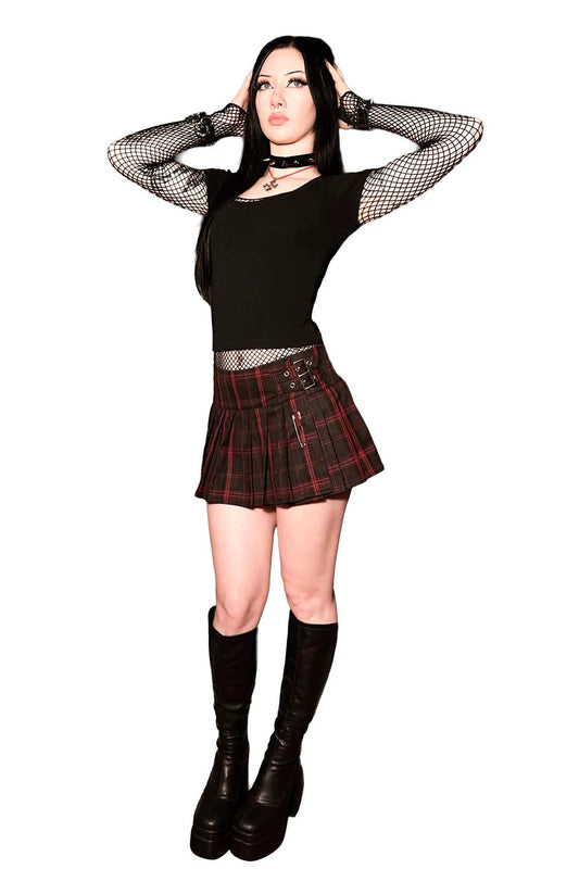 Person wearing a lip service world end pleated mini skirt black top, plaid skirt, and black boots on a white background