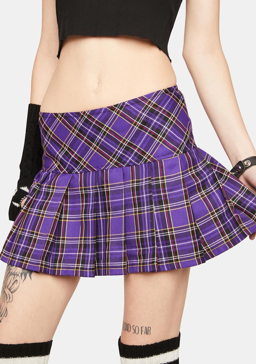 Purple plaid skirt worn by a person on a white background