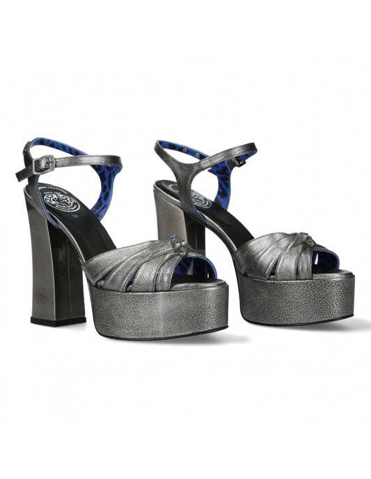 Pair of high-heeled platform shoes with black and blue design on a white background