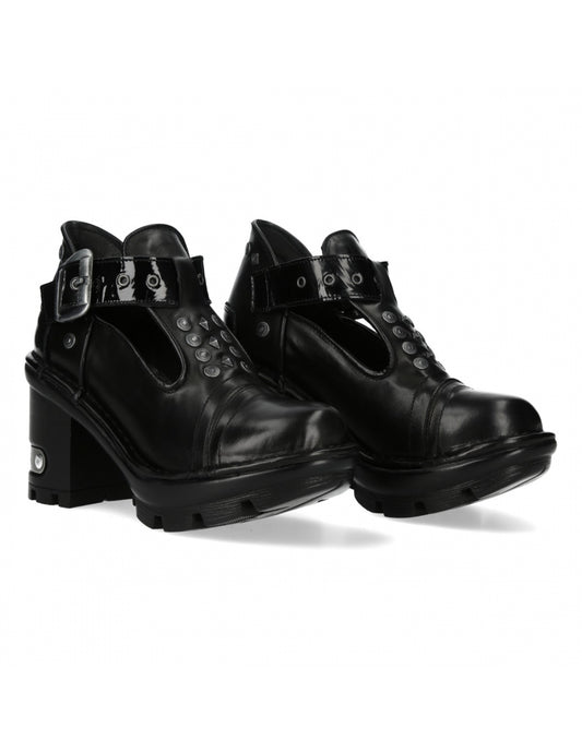 Pair of black leather boots with buckles on a white background