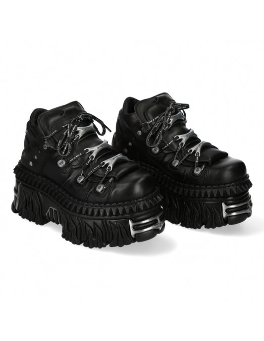 Pair of black platform boots on a white background