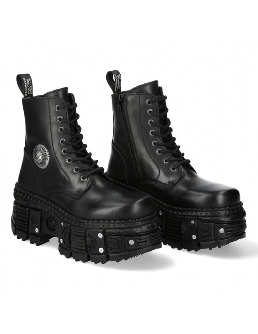 Pair of black leather boots with unique sole design on a white background