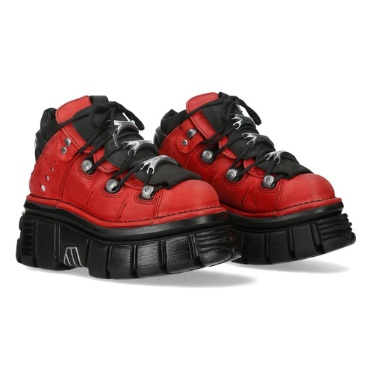 Red and black high-top sneakers with thick soles on a white background