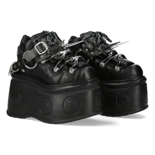 Black platform shoes with decorative elements on a white background