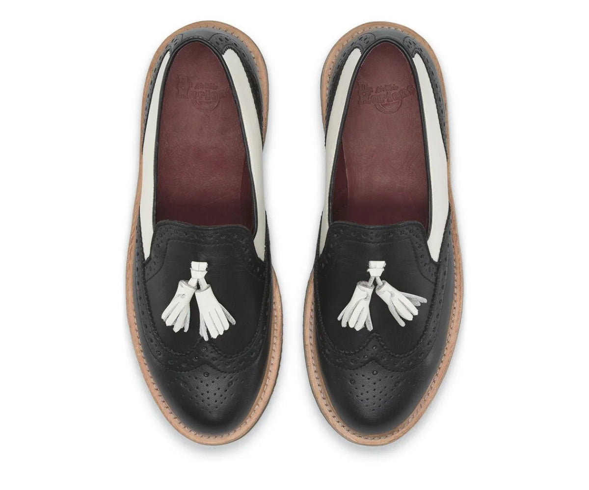 Pair of black loafers with tassel details on a white background