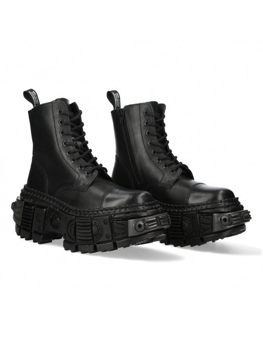 Pair of black leather boots with chunky soles on a white background