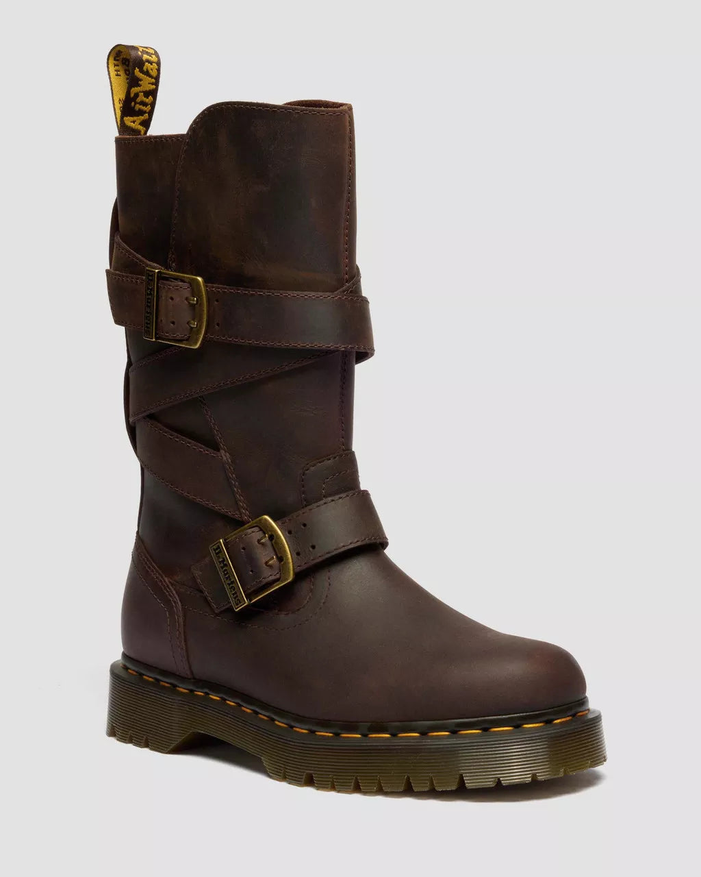 Brown leather boot with buckles on a light gray background