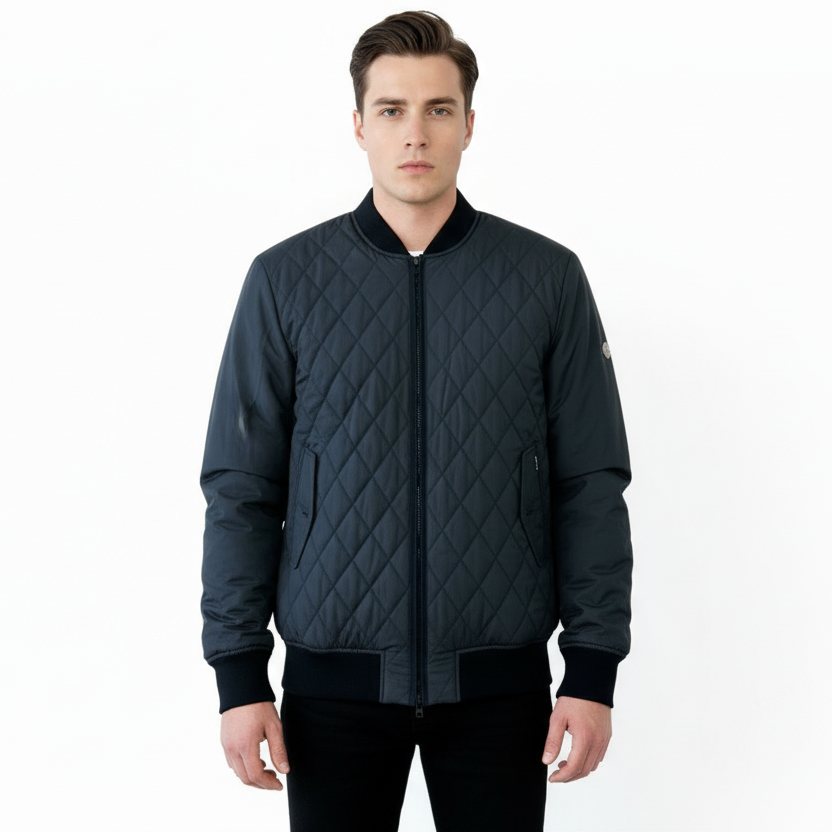 Man wearing a dark quilted jacket on a white background