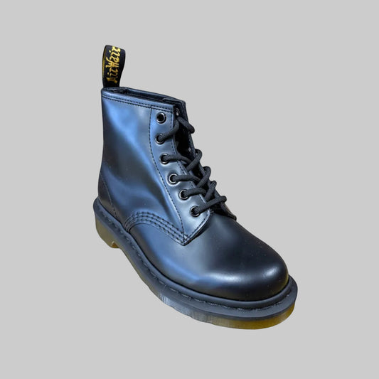 Blue leather boot with a yellow sole on a light gray background