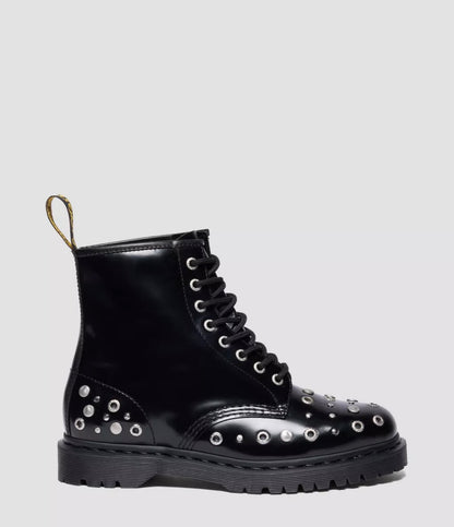 Black leather boot with studs on a light gray background