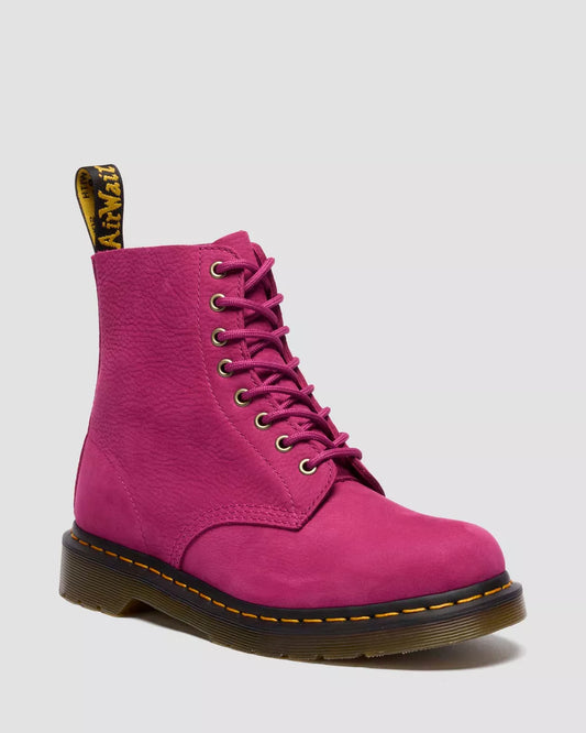Pink boot with black sole on a light gray background