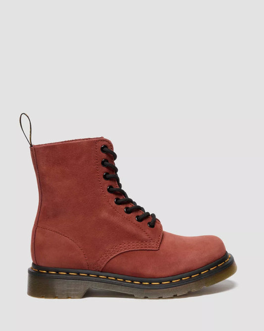 Red leather boot with black laces on a light gray background