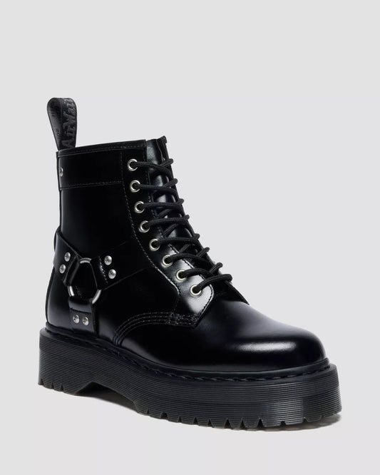 Black leather boot with unique design elements on a light gray background