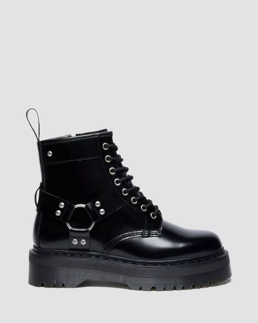 Black leather boot with metallic accents on a light gray background