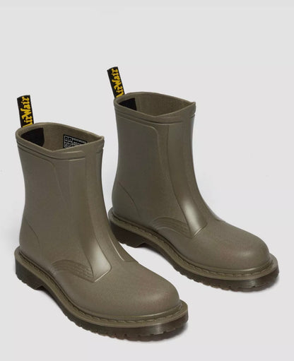 Pair of green rubber boots on a light gray background