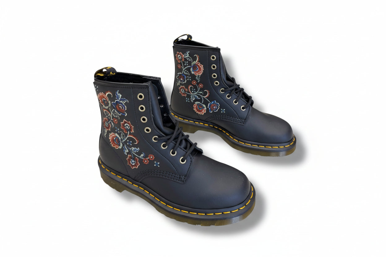Navy blue boots with floral embroidery on a white background
