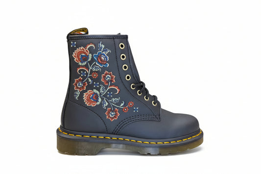 Blue boot with floral embroidery on a white background
