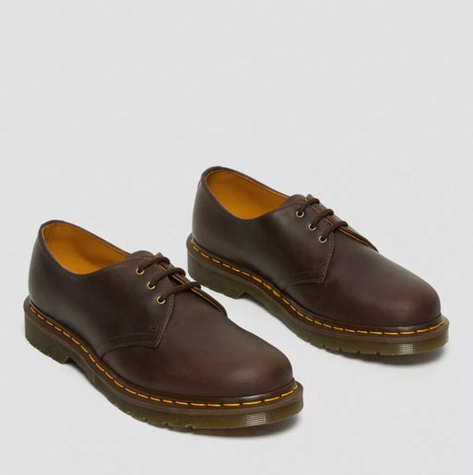 Pair of brown leather shoes on a light gray background