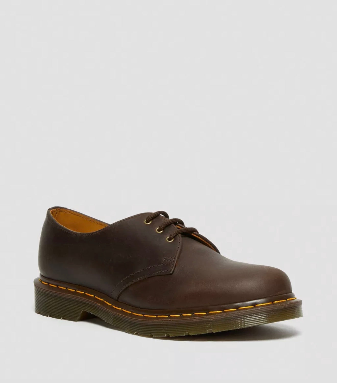Brown leather shoe on a light gray background
