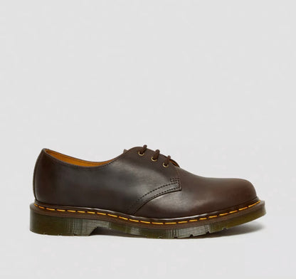 Brown leather shoe on a light gray background