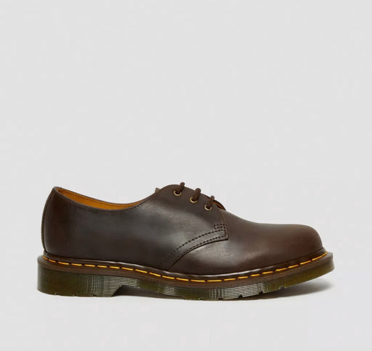 Brown leather shoe on a light gray background