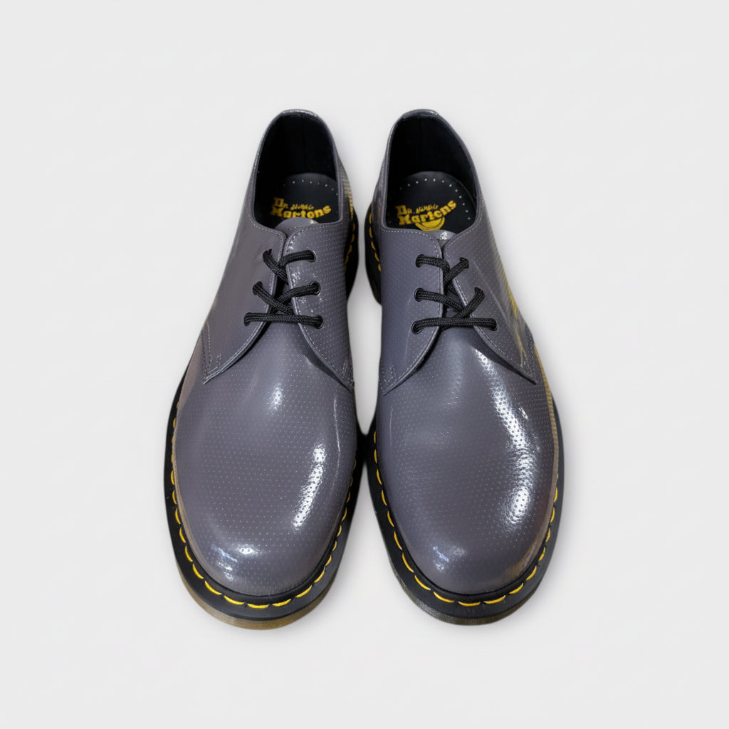 Pair of gray shoes with black soles on a white background