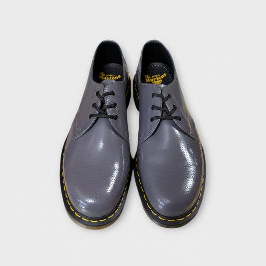 Pair of gray shoes with black soles on a white background