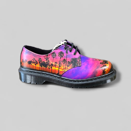 Shoe with colorful palm tree design on a gray background