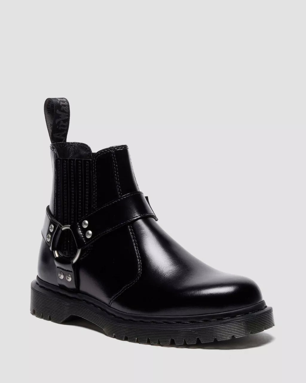 Black leather boot with buckle detail on a light gray background