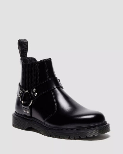 Black leather boot with buckle detail on a light gray background