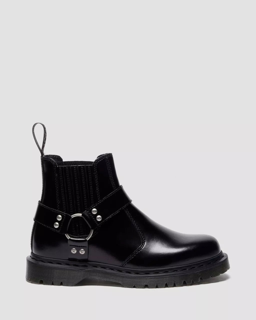 Black leather boot with buckle detail on a light gray background