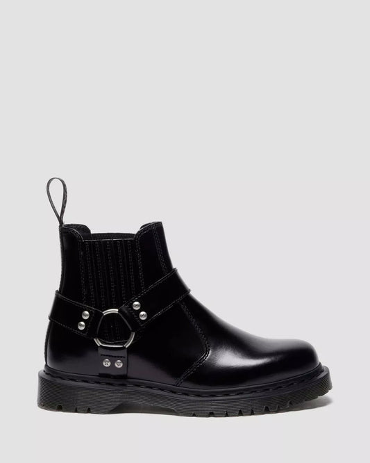 Black leather boot with buckle detail on a light gray background