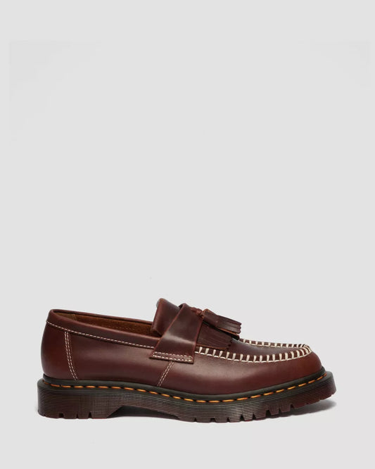 Brown loafer shoe on a light gray background
